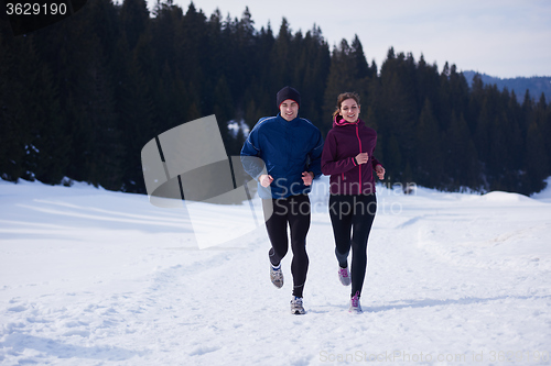 Image of couple jogging outside on snow