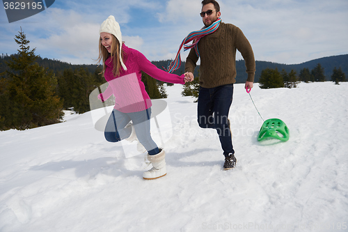 Image of happy young couple having fun on fresh show on winter vacation