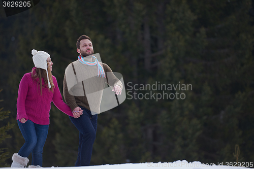 Image of couple having fun and walking in snow shoes