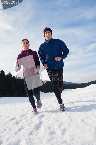 Image of couple jogging outside on snow