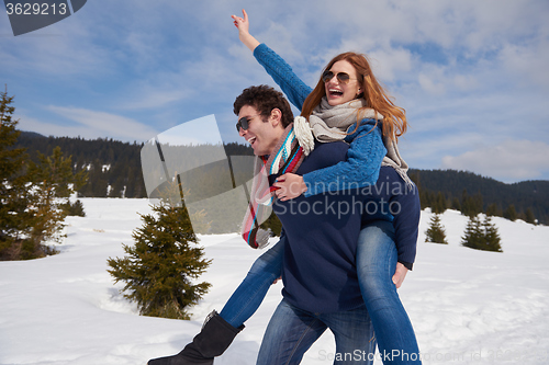 Image of happy young couple having fun on fresh show on winter vacation