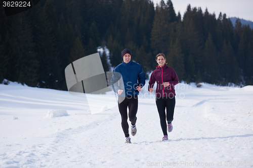 Image of couple jogging outside on snow