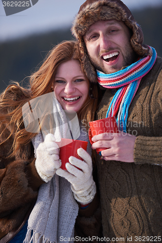 Image of couple drink warm tea at winter