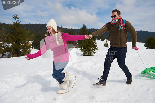 Image of happy young couple having fun on fresh show on winter vacation