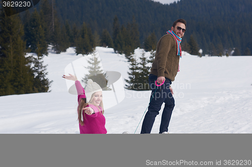 Image of happy young couple having fun on fresh show on winter vacation