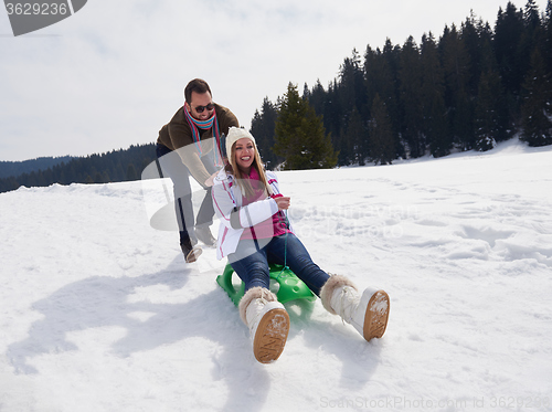 Image of happy young couple having fun on fresh show on winter vacation