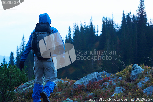 Image of advanture man with backpack hiking