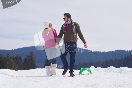 Image of happy young couple having fun on fresh show on winter vacation