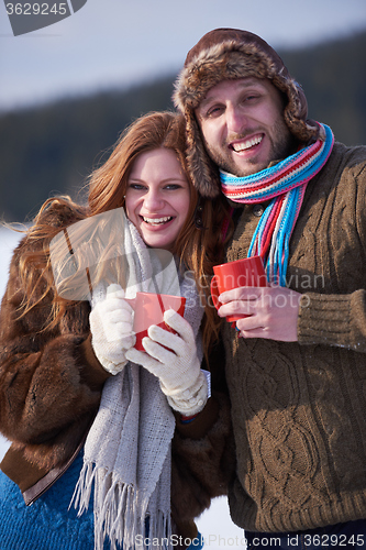 Image of couple drink warm tea at winter