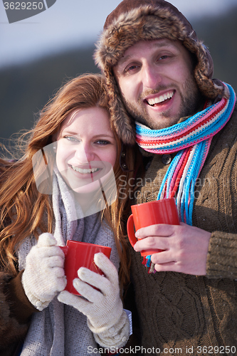 Image of couple drink warm tea at winter