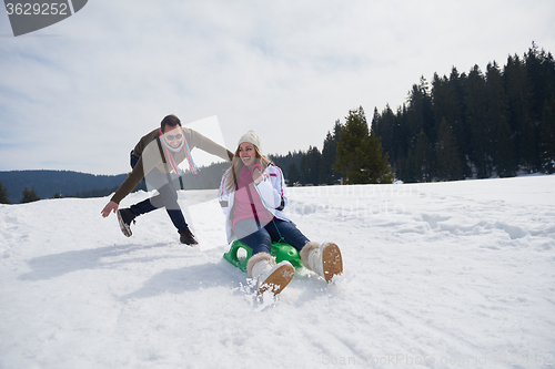 Image of happy young couple having fun on fresh show on winter vacation