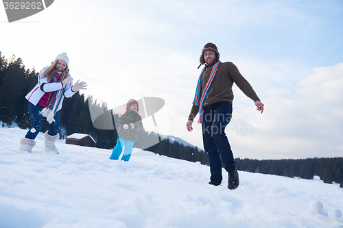 Image of happy family playing together in snow at winter