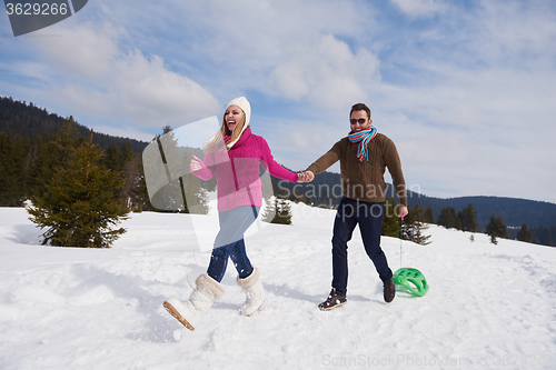 Image of happy young couple having fun on fresh show on winter vacation