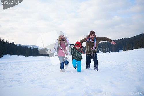 Image of happy family playing together in snow at winter