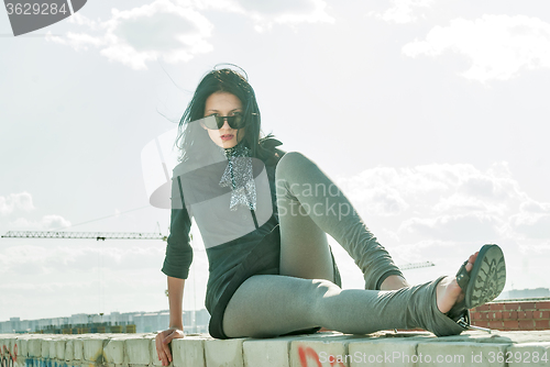 Image of Young pretty woman on roof