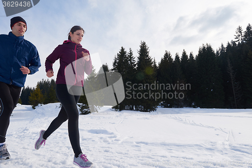 Image of couple jogging outside on snow