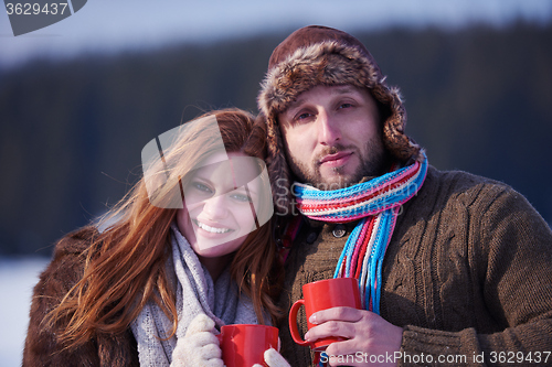 Image of couple drink warm tea at winter