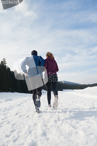 Image of couple jogging outside on snow