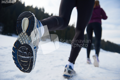 Image of couple jogging outside on snow