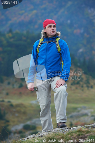 Image of advanture man with backpack hiking