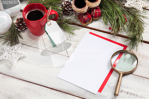 Image of The blank sheet of paper on the wooden table with a pen 