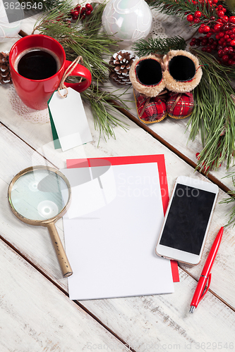 Image of The blank sheet of paper on the wooden table with a pen 