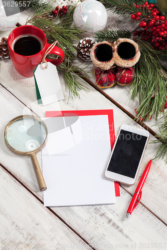 Image of The blank sheet of paper on the wooden table with a pen 