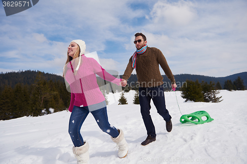 Image of happy young couple having fun on fresh show on winter vacation