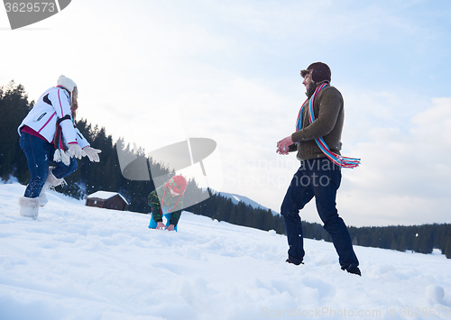 Image of happy family playing together in snow at winter