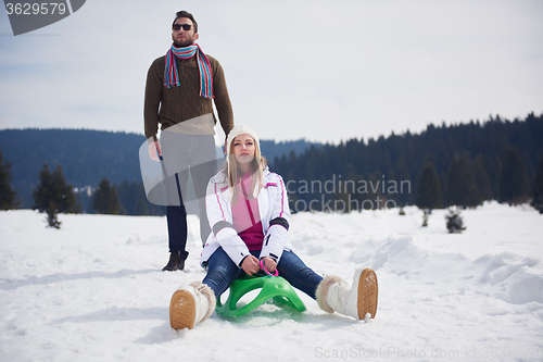 Image of happy young couple having fun on fresh show on winter vacation