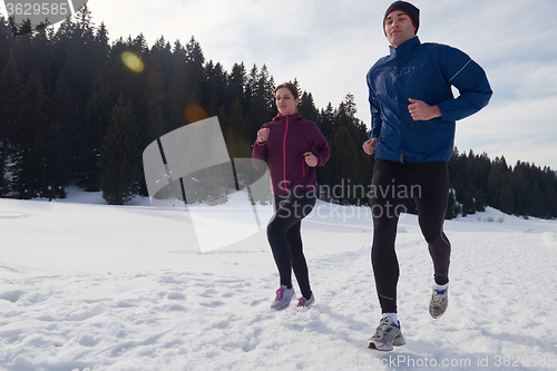 Image of couple jogging outside on snow