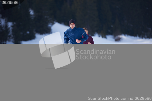 Image of couple jogging outside on snow