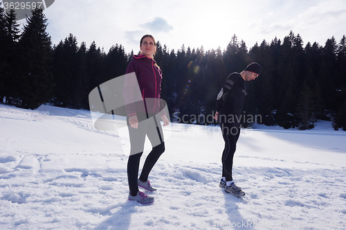 Image of couple jogging outside on snow