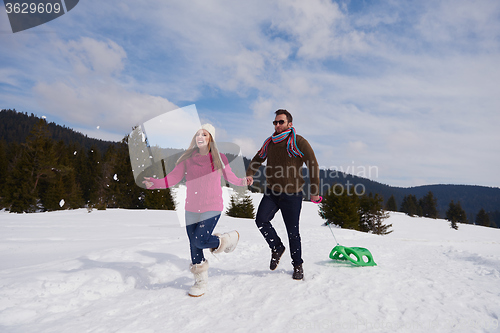 Image of happy young couple having fun on fresh show on winter vacation