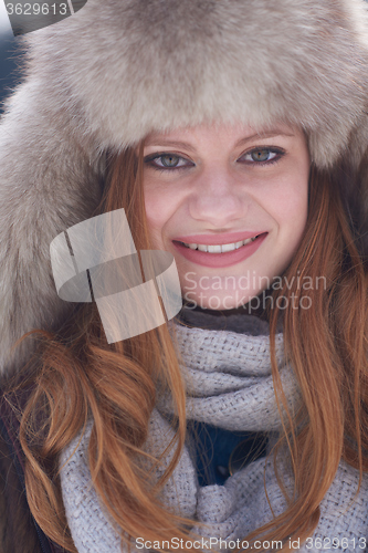 Image of portrait of beautiful young redhair woman in snow scenery