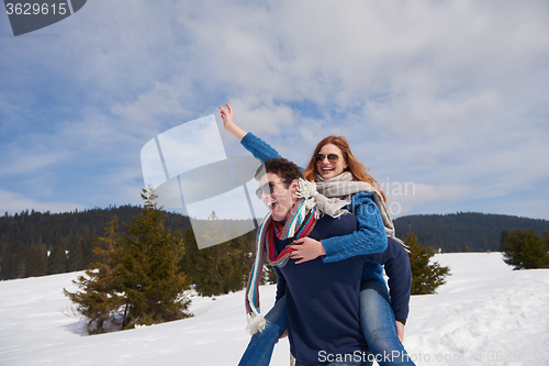 Image of happy young couple having fun on fresh show on winter vacation