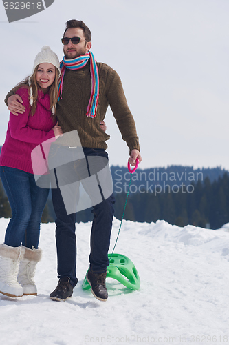 Image of happy young couple having fun on fresh show on winter vacation