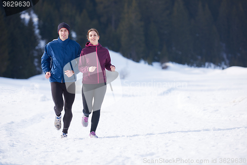 Image of couple jogging outside on snow