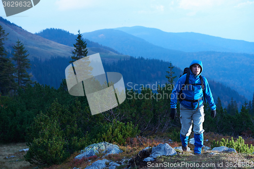 Image of advanture man with backpack hiking