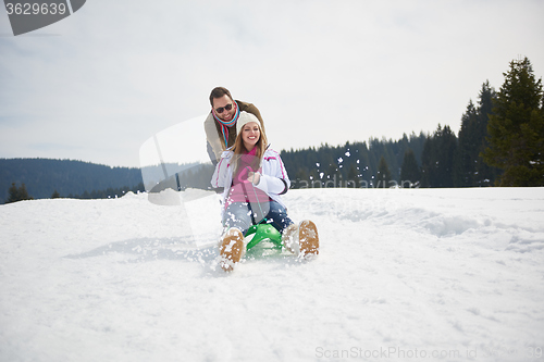 Image of happy young couple having fun on fresh show on winter vacation