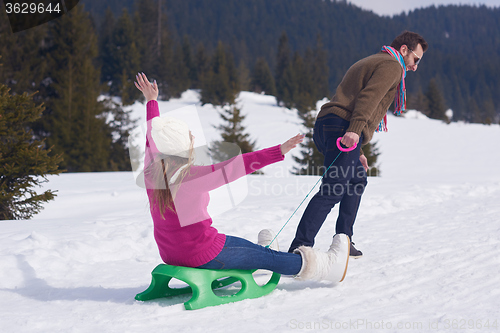 Image of happy young couple having fun on fresh show on winter vacation