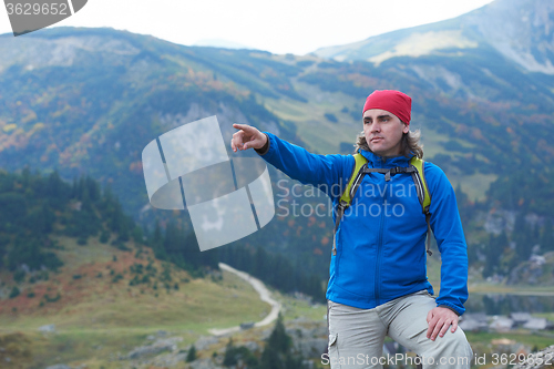 Image of advanture man with backpack hiking