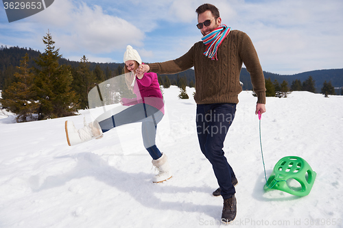 Image of happy young couple having fun on fresh show on winter vacation