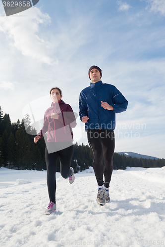 Image of couple jogging outside on snow