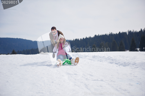 Image of happy young couple having fun on fresh show on winter vacation