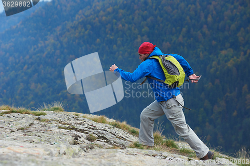 Image of advanture man with backpack hiking