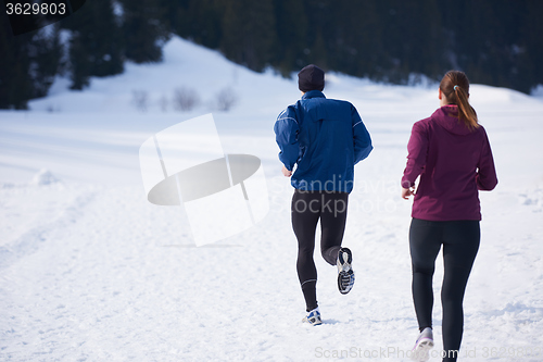 Image of couple jogging outside on snow