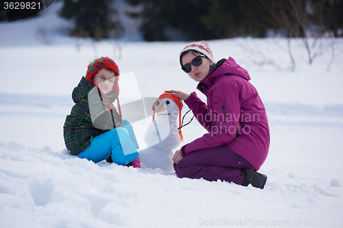 Image of happy family building snowman