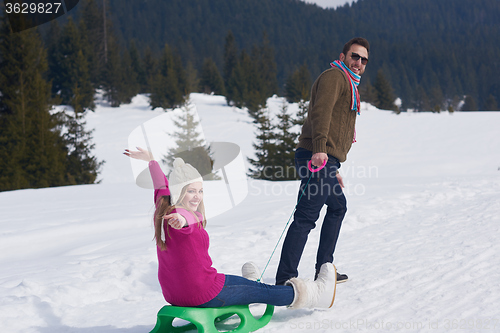 Image of happy young couple having fun on fresh show on winter vacation