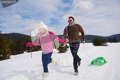 Image of happy young couple having fun on fresh show on winter vacation